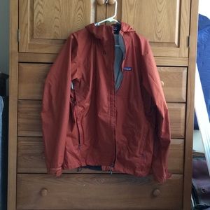 Patagonia Torrentshell.   Light rain/wind shell.